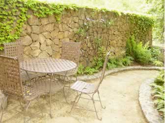 The garden wall is in proper scale to the table and chairs: offering privacy whether sitting or standing.